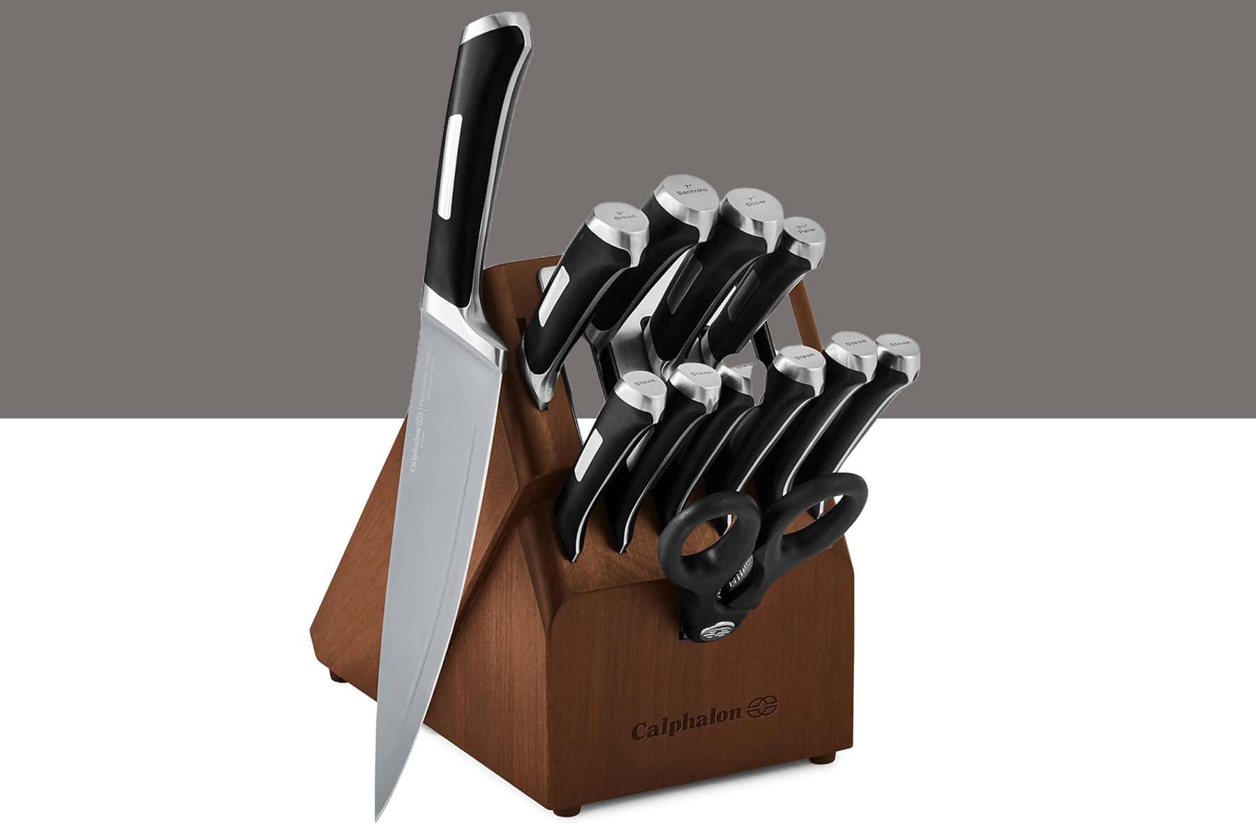 Best Budget Kitchen Knife Sets Under $100 - Image 11 The Calphalon 13-piece self-sharpening knife set shown here with the chef knife outside the storage block in front of a split gray and white background.