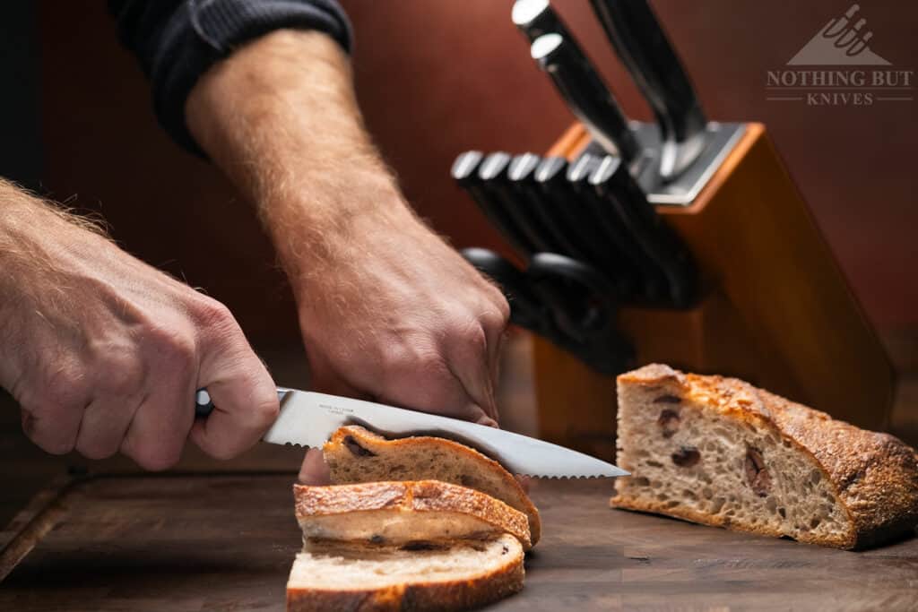 This knife set does not ship with a bread knife, but the 6 inch serrated utility knife gets the job done. 