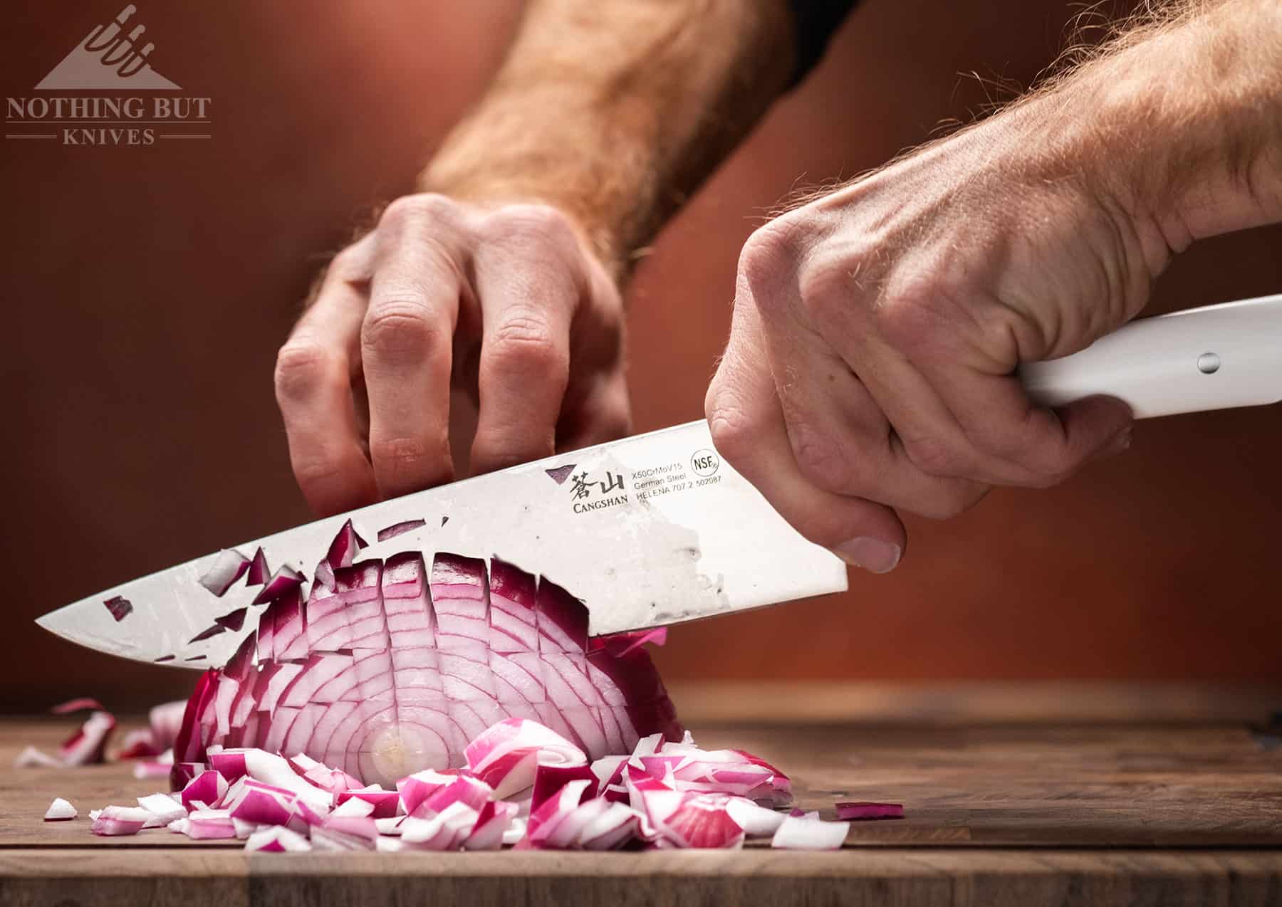 Dicing an onion with the impressive Cangshan Helena 8-inch chef knife. Its performance is one of the main reasons we chose this set as one of the best under $200.