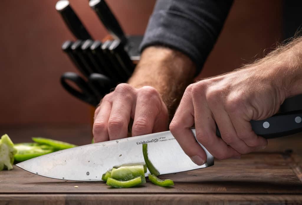 https://www.nothingbutknives.com/wp-content/uploads/2017/03/Cutting-Peppers-with-the-Calphalon-Classic-Chef-Knife-1024x693.jpg