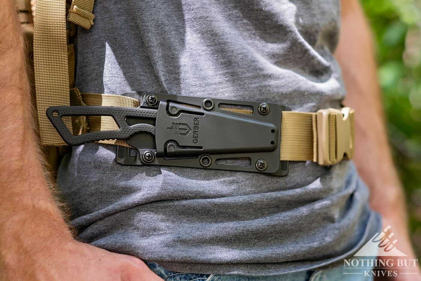 Gerber Ghostrike tactical knife in it's sheath attached to a backpack. 
