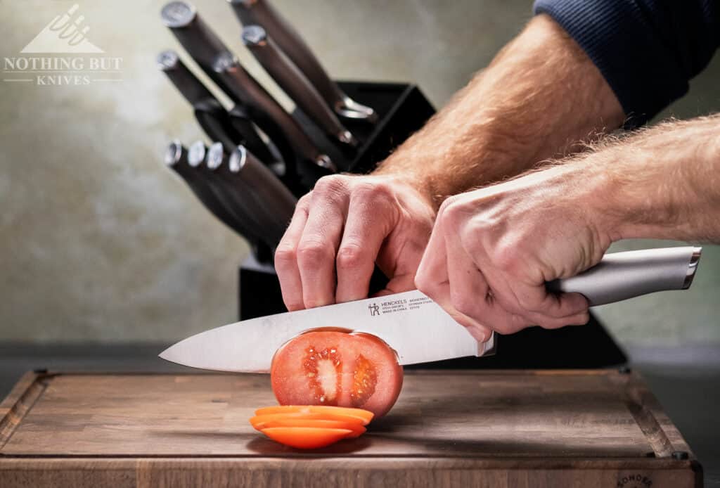 Effortlessly slicing through a tomato with the 8 inch chef knife from the 13-pice Henckels Modernist set.
