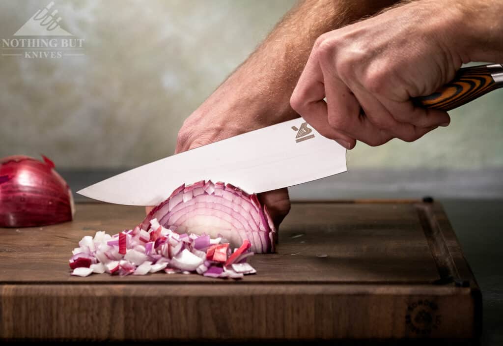 The tapered handle and tall blade of the MSY BigSunny chef knife make it ideal for dicing an onion. 