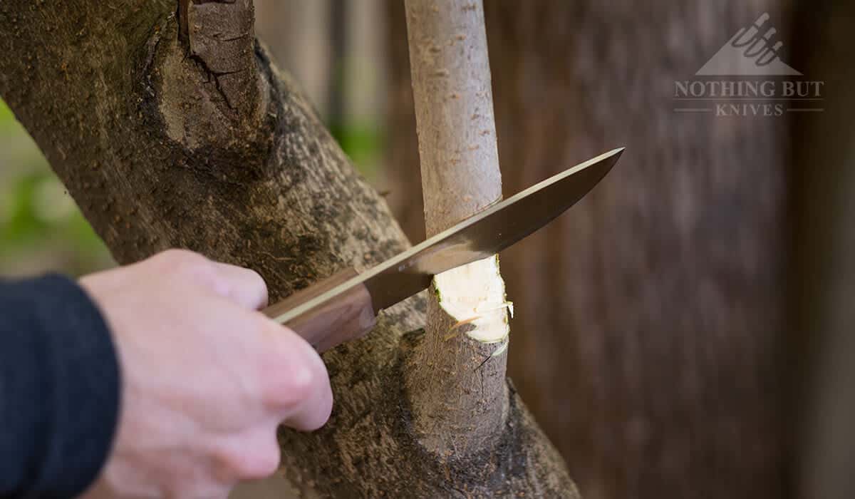 Condor Swamp Romper Review - Image 7 Condor Swamp Romper chopping a branch.