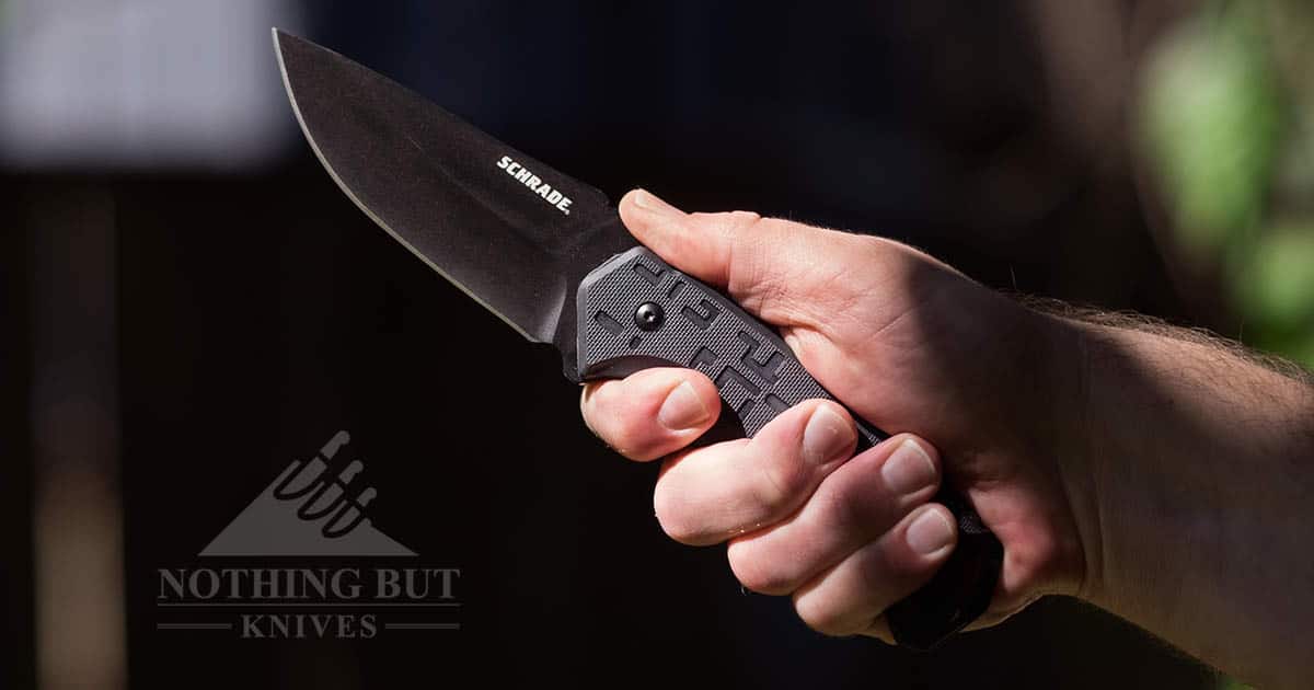 Schrade full tang fixed blade bushcraft knife in hand