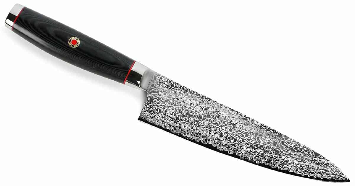 The SG2 8 inch chef knife from Enso tilted at an angle on a white background.