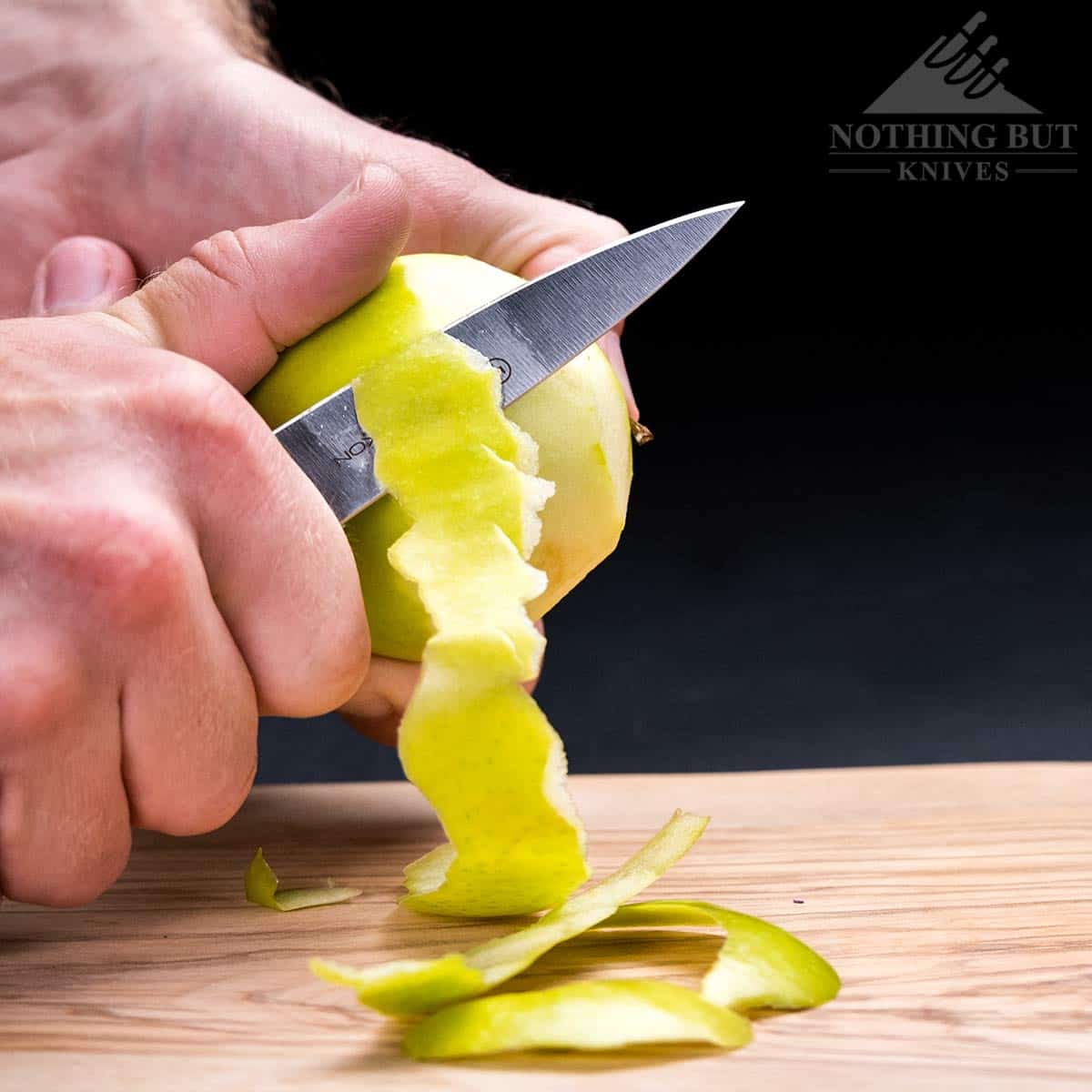 Cutting the peel off an apple with the Wusthof Classic Ikon 3.5 inch paring knife. 