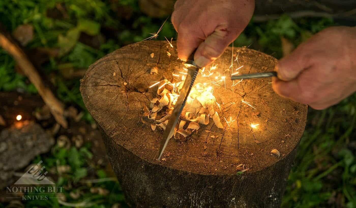 Buck Selkirk Knife Review - Image 7 The Selkirk throwing sparks off a ferro rod into a pile of curled wood shavings.