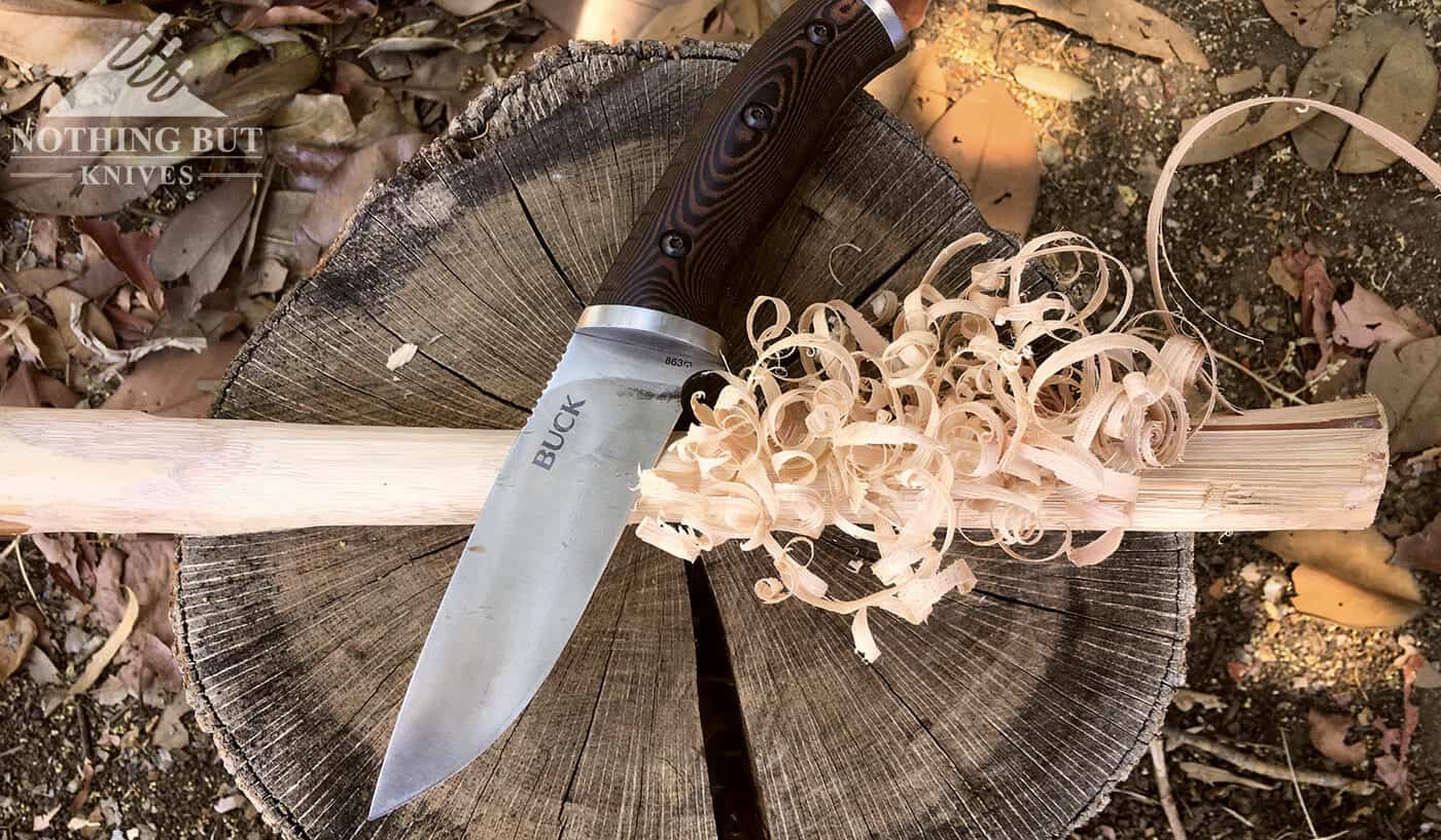 Buck Selkirk Knife Review - Image 10 The Buck Selkirk lying on top of a completed feather stick.