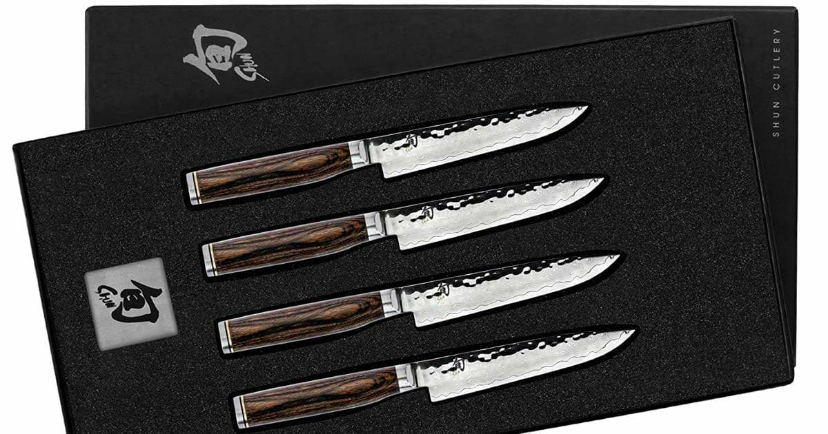The Ultimate Guide To Shun Knives And Knife Block Sets - Image 21 The 4 Piece Shun Premier Steak Knife Set shown in it's box next to the Shun logo.