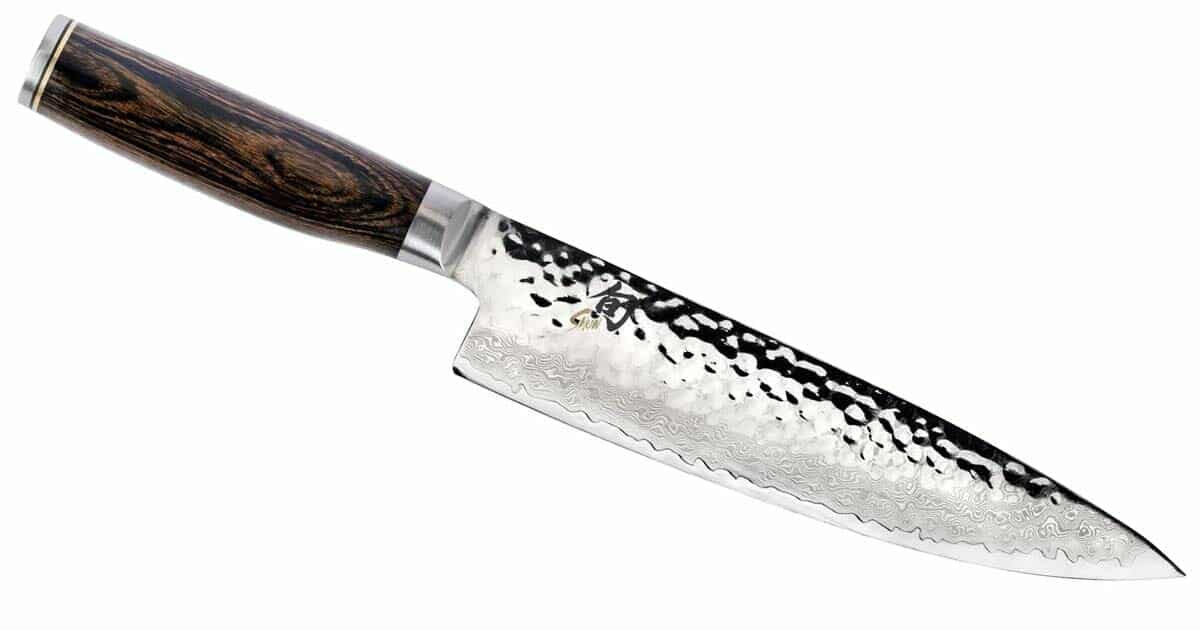 The Shun Premiere 8 inch chef knife tiltwed to the right on a white background. 