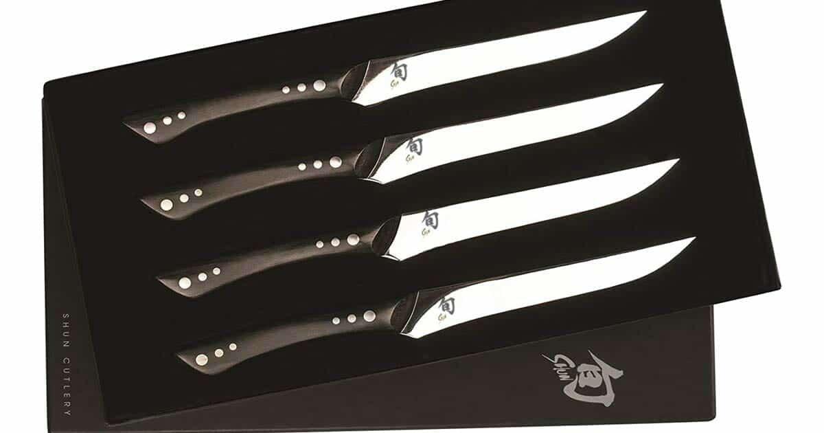 The Ultimate Guide To Shun Knives And Knife Block Sets - Image 22 4 Piece Shima Steak Knife Set from Shun inside a nice black box next to the Shun logo.