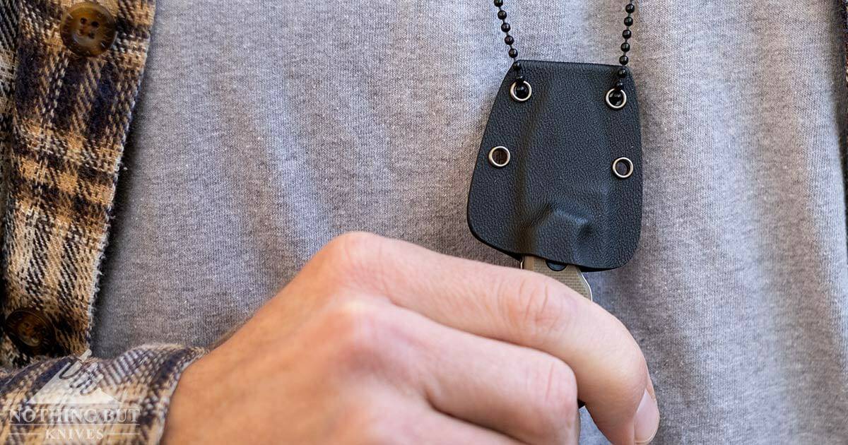 Boker Magnum EDC neck knife being worn around a man's chest. 