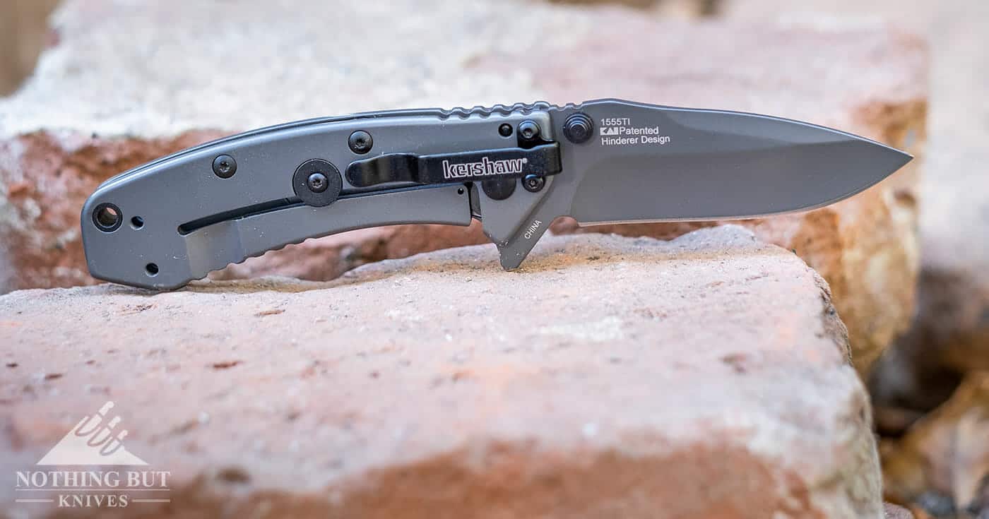 The Kershaw Cryo 1555Ti pocket knife sitting on a dusty pile of bricks.