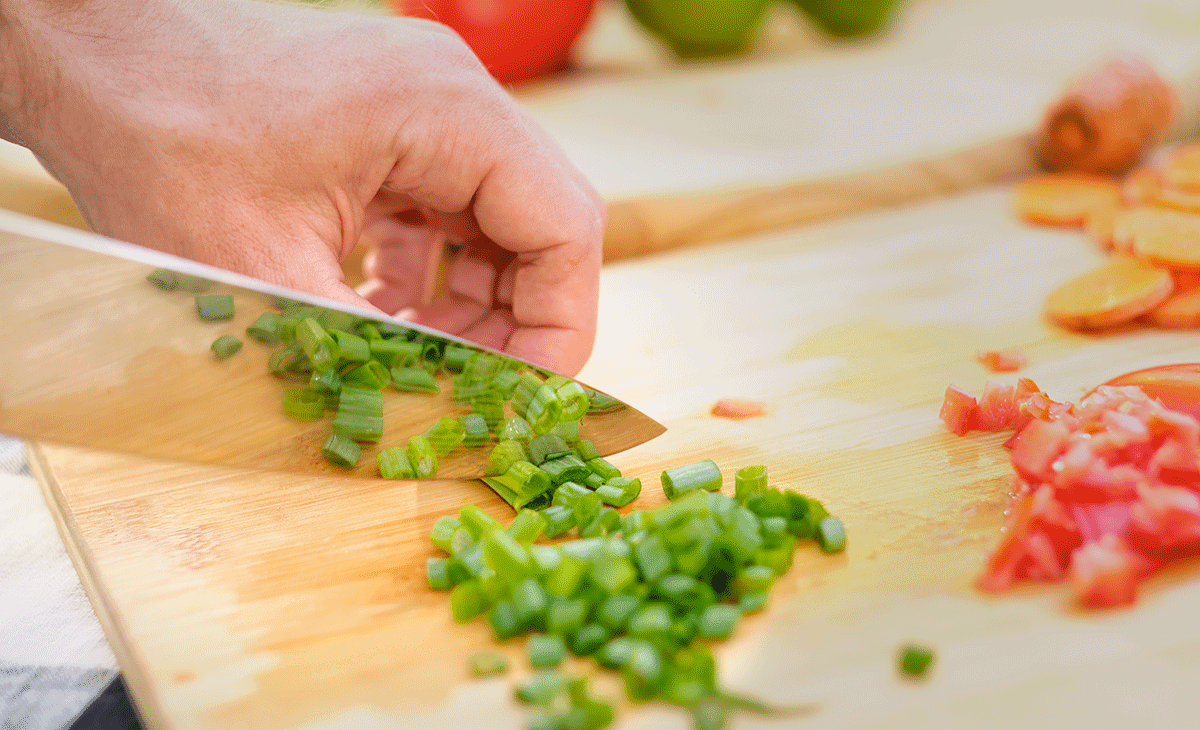 Mosfiata 8-Inch Chef Knife Review - Image 6 Chef knife cutting green onions.