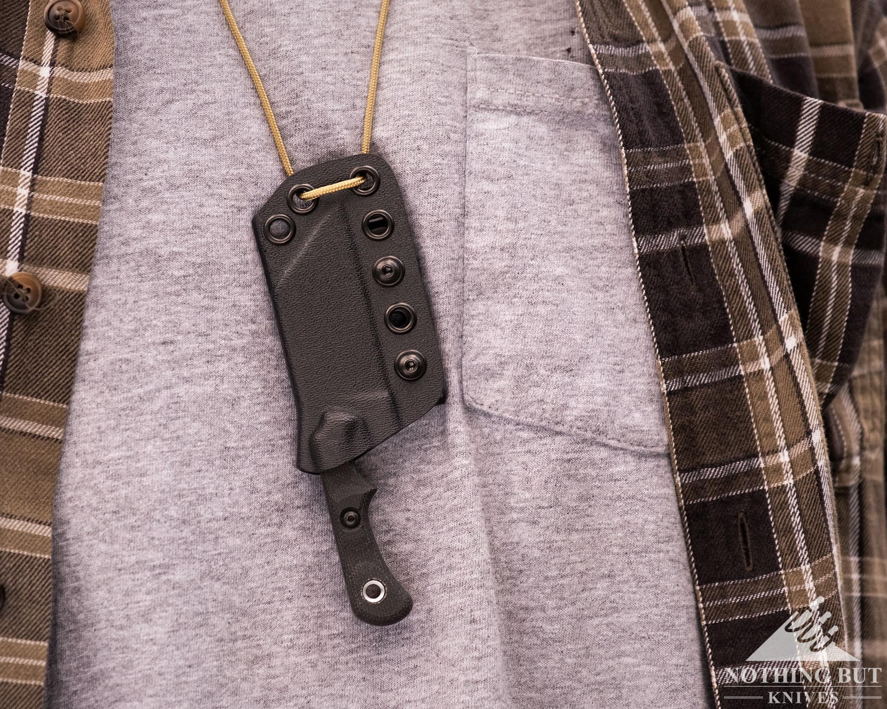 The TOPS Ivie fixed blade neck knife on paracord for easy deployment.