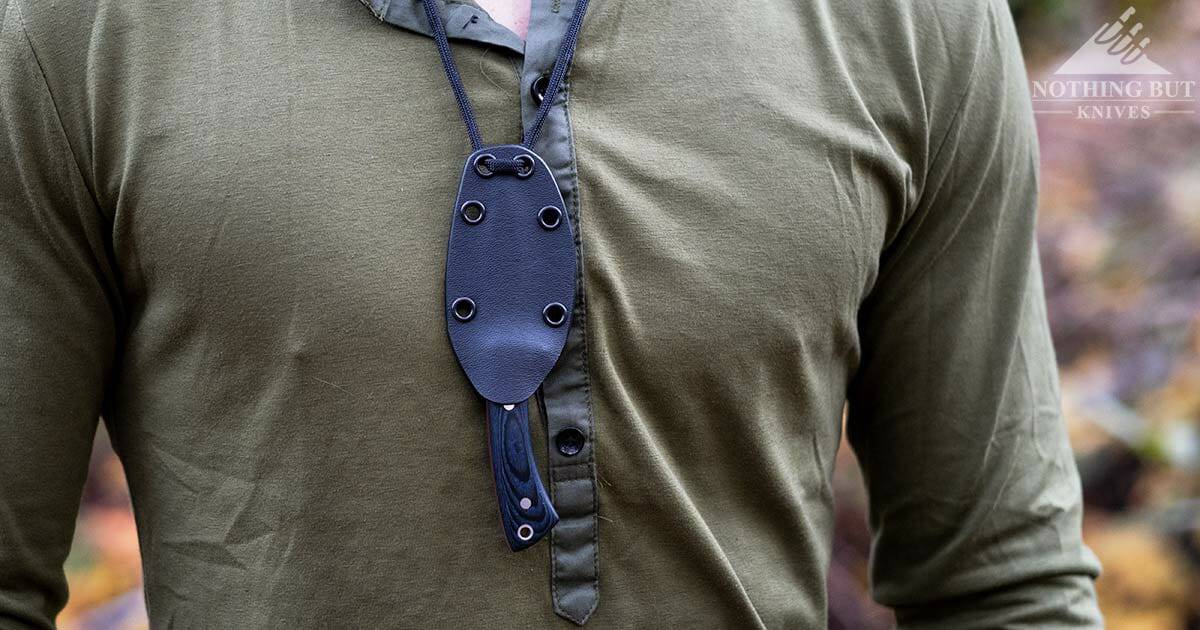 Close up of the Victorinox Outdoor Master Mic S being worn on a man's neck on the outside of a green shirt. 