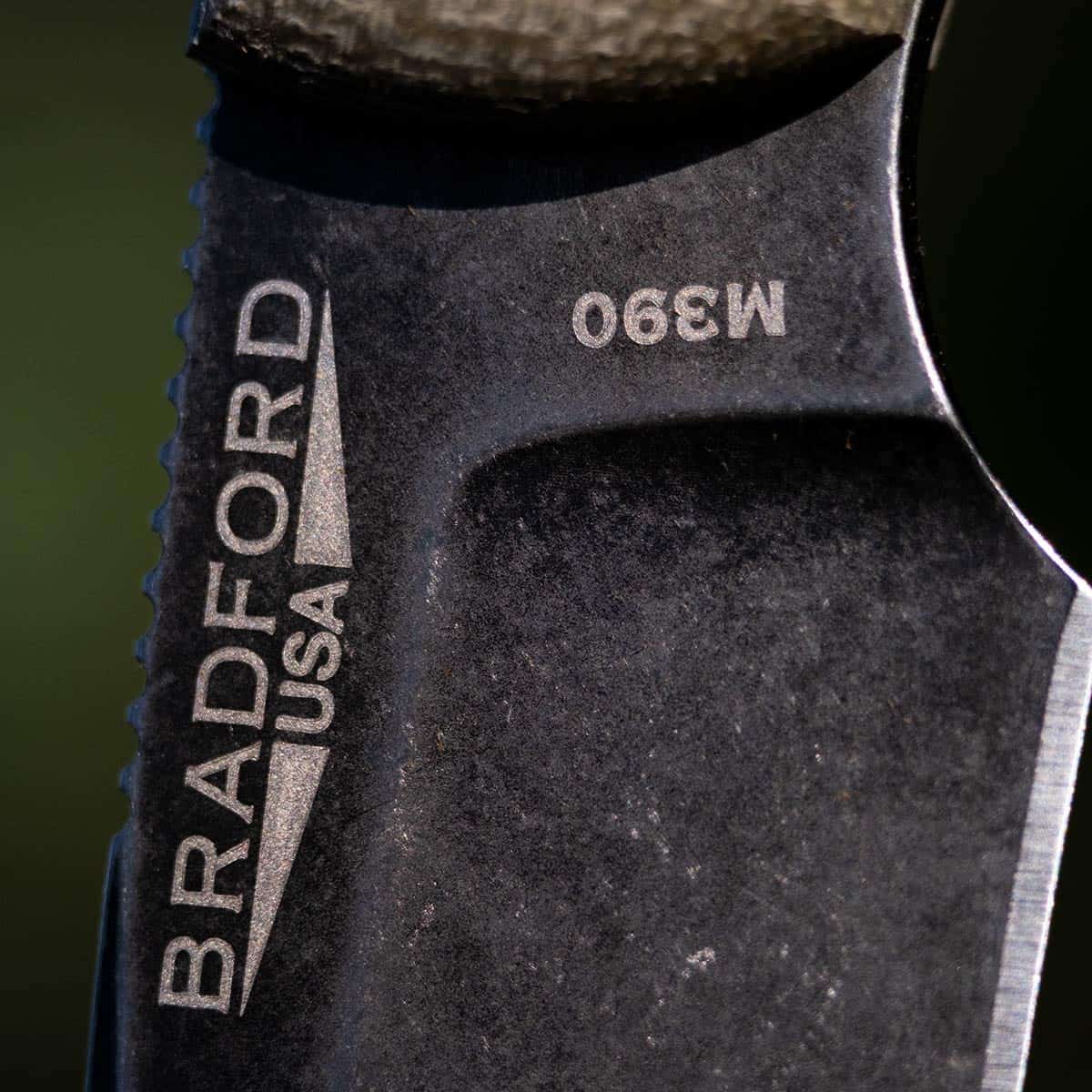 Close-up image showing the branding and steel type of the Bradford Guardian knife. 