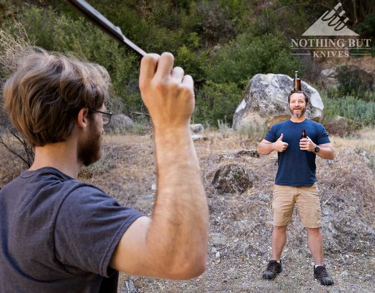 A joke image showing a man pretending to knock a beer bottle of the head of his brother. 