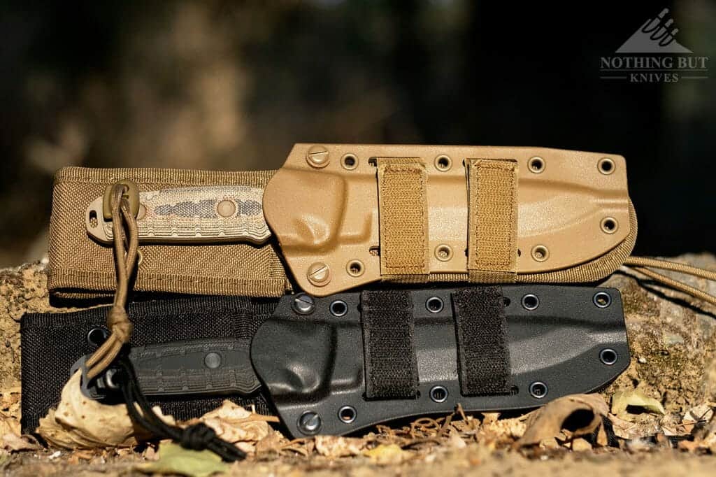Two Buck GCK knives in their sheaths outdoors.