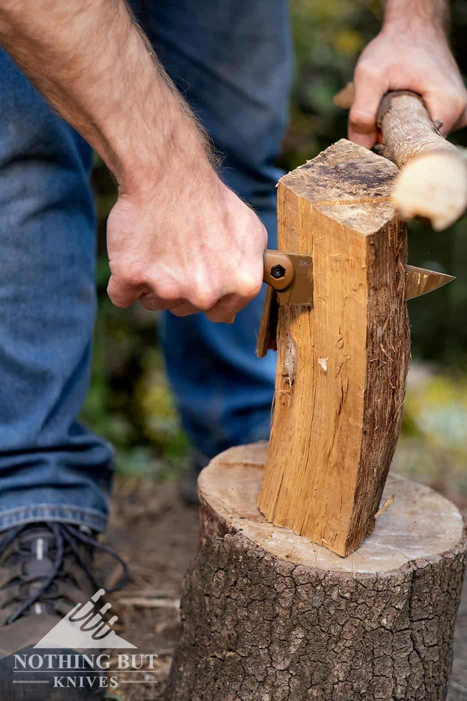 A close-up of a man making kindling with a Ka-Bar survival knife.