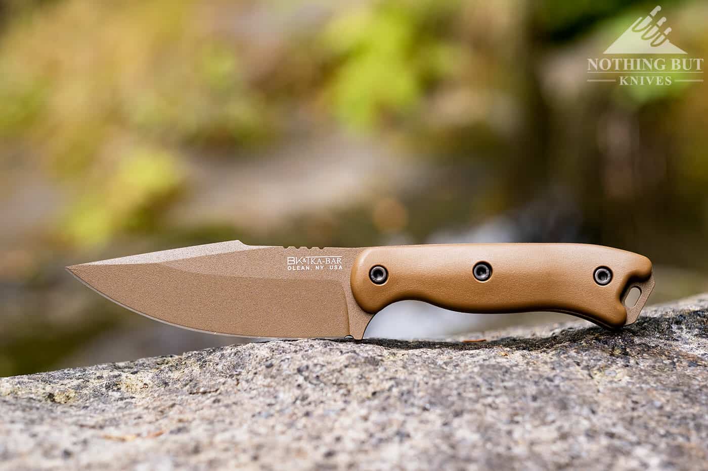 The Ka-Bar Becker BK18 sitting on granite next to a mountain creek.