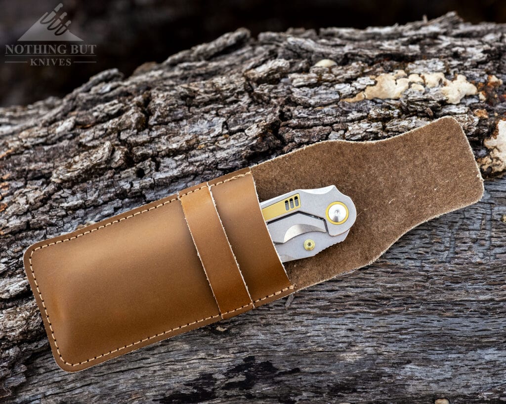 An overhead view of the orbital Fornax in its brown, leather sheath. 
