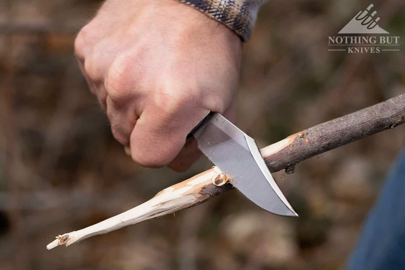 The LionSteel Gitano in action carving a point on a hot dog roasting stick. 