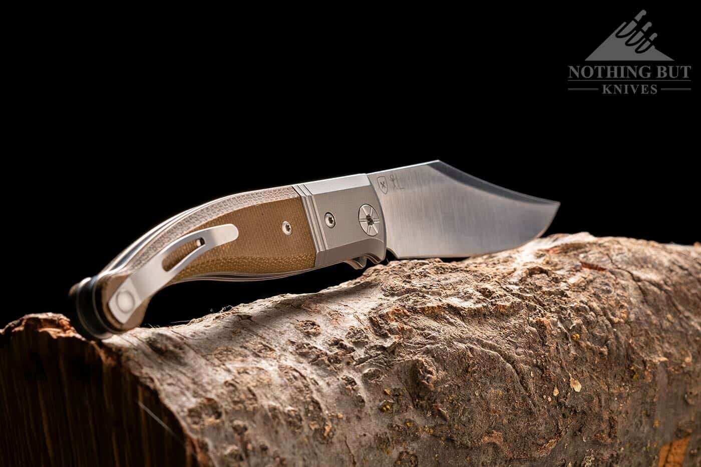 The LionSteel Gitano on a tree branch with the handle facing forward. 