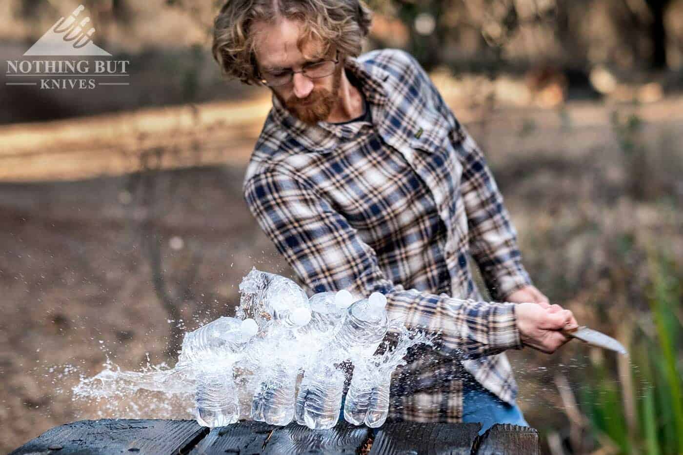 Testing the tactical ability of the Ka-Bar Becker Harpoon by slicing through water bottles. 