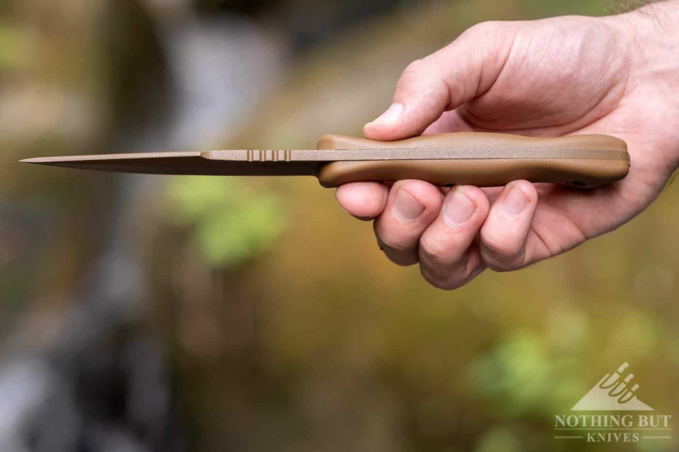 The Ka-Bar Becker BK18 knife turned with the spine facing the camera to show the hook of the harpoon shape. 