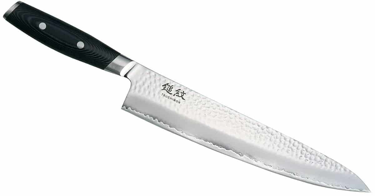 Yaxell Knives And Knife Set Buyers Guide - Image 6 The Yaxell Tsuchimon 8 inch chef knife with the blade angled to the right on a white background.