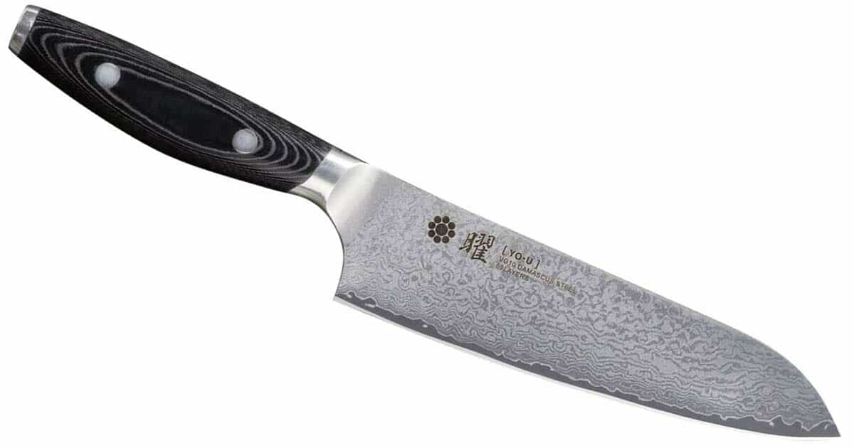 The Yaxell Yo_U Santoku knife tilted with the blade pointed toward the bottom right hand corner kn a white background. 
