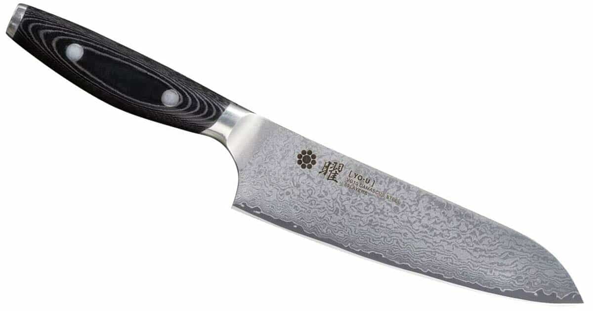 Yaxell Knives And Knife Set Buyers Guide - Image 9 The Yaxell Yo_U Santoku knife tilted with the blade pointed toward the bottom right hand corner kn a white background.