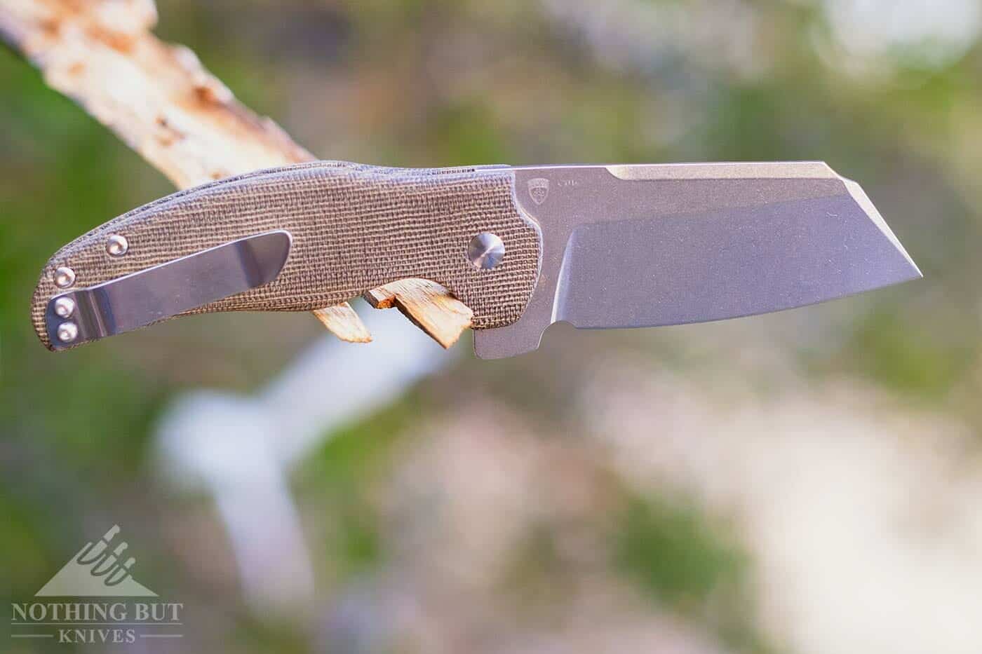 Kizer Sheepdog Knife Review - Image 1 Overall Length: 7.75” Blade Length: 3.25” Blade Width: 0.13” Blade Steel: CTS-BD1N Handle Length: 3.4” Blade shape: Sheepsfoot Blade Grind: Flat Handle Material: Canvas Micarta Lock Type: liner Weight: 4.5 oz Pros Tough design with great materials Great fit and finish with a clean action Good ergonomics with grippy Micarta Good utility edge for push cuts Cons Huge in the pocket Damn heavy blade Right-hand-only pocket clip
