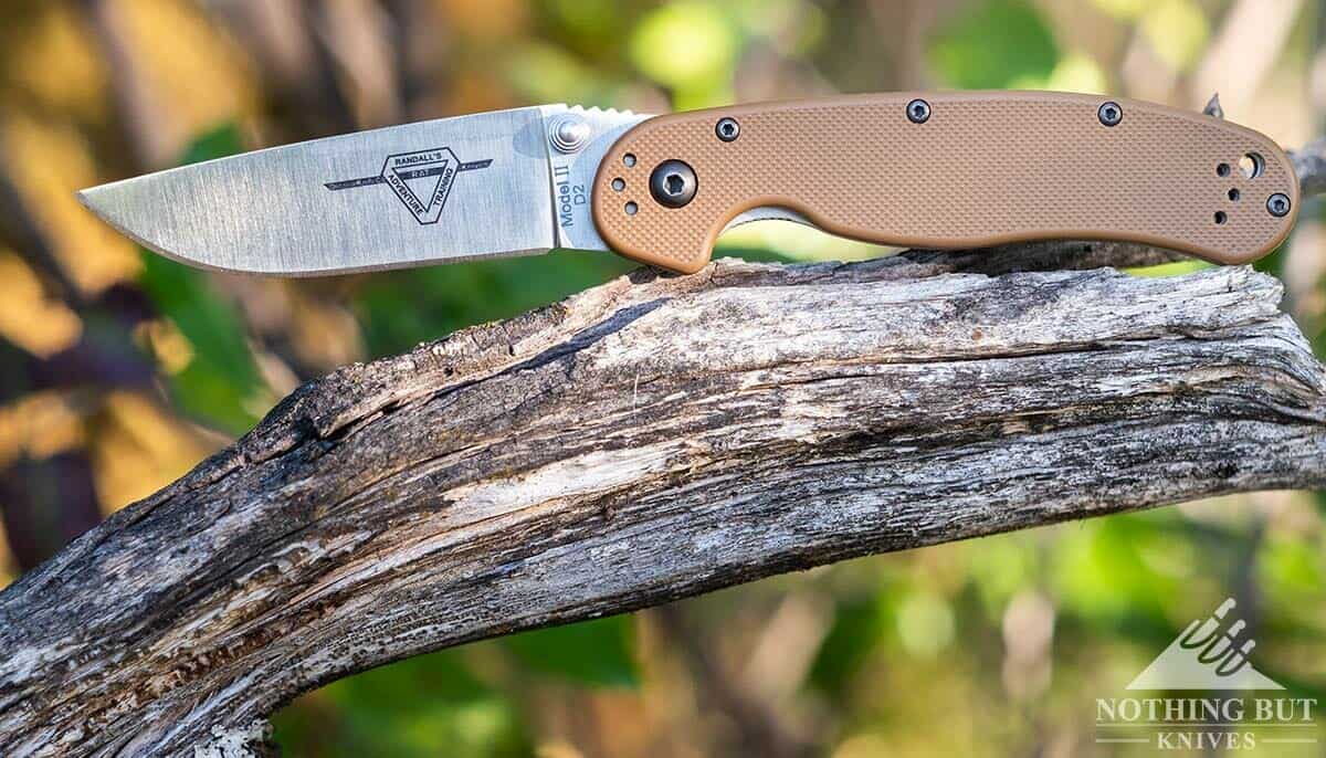 The Ontario Rat 2 Pocket Knife with a D2 steel blade in the open position in the forest. 