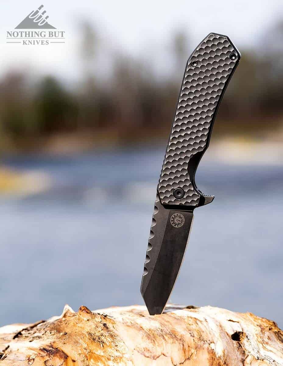 Off-Grid Black Mamba blade in a branch on the side of a river.