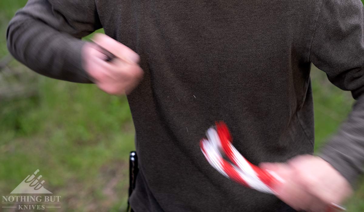 A close-up of a man cutting rope with the Gerber Sedulo.