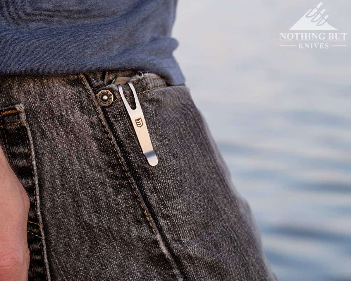 A close-up of the 3V Gear React in the pocket of a man's jeans. 