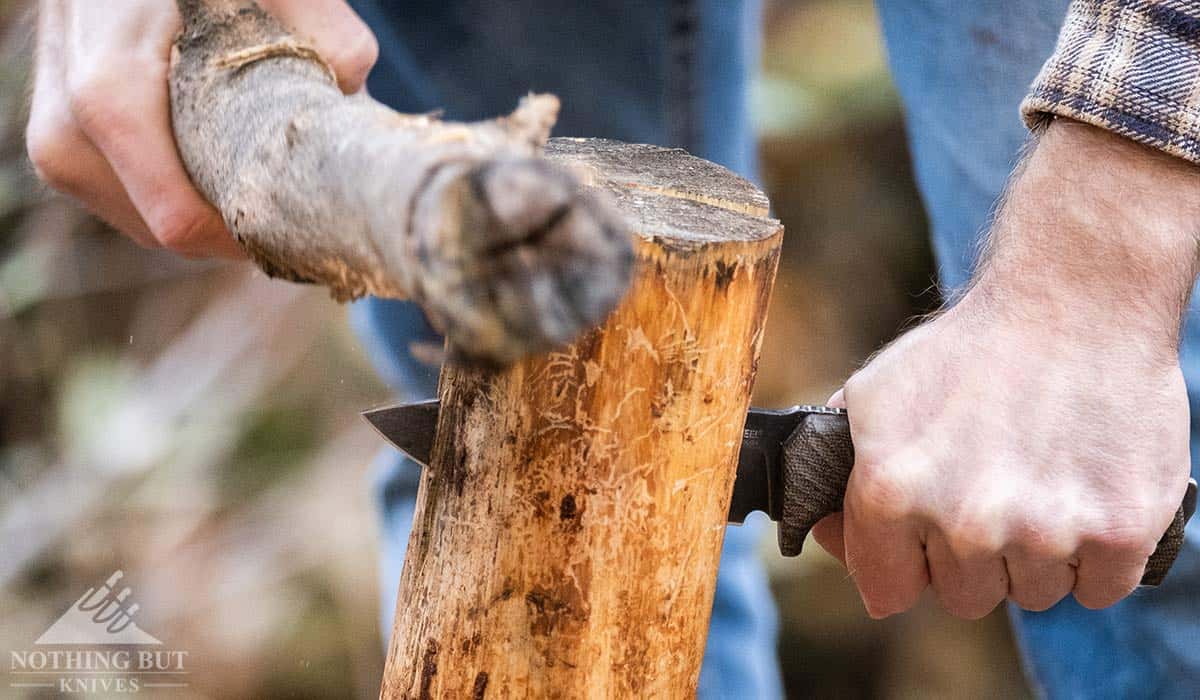 A close-up of a log being batoned with the Lionsteel T5. 