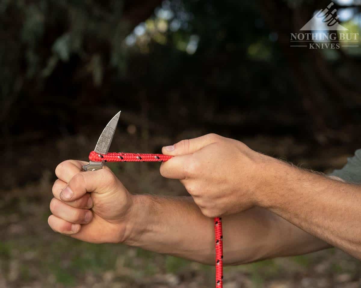3V Gear React Knife Review - Image 5 The Ract knife about to slice through rope.