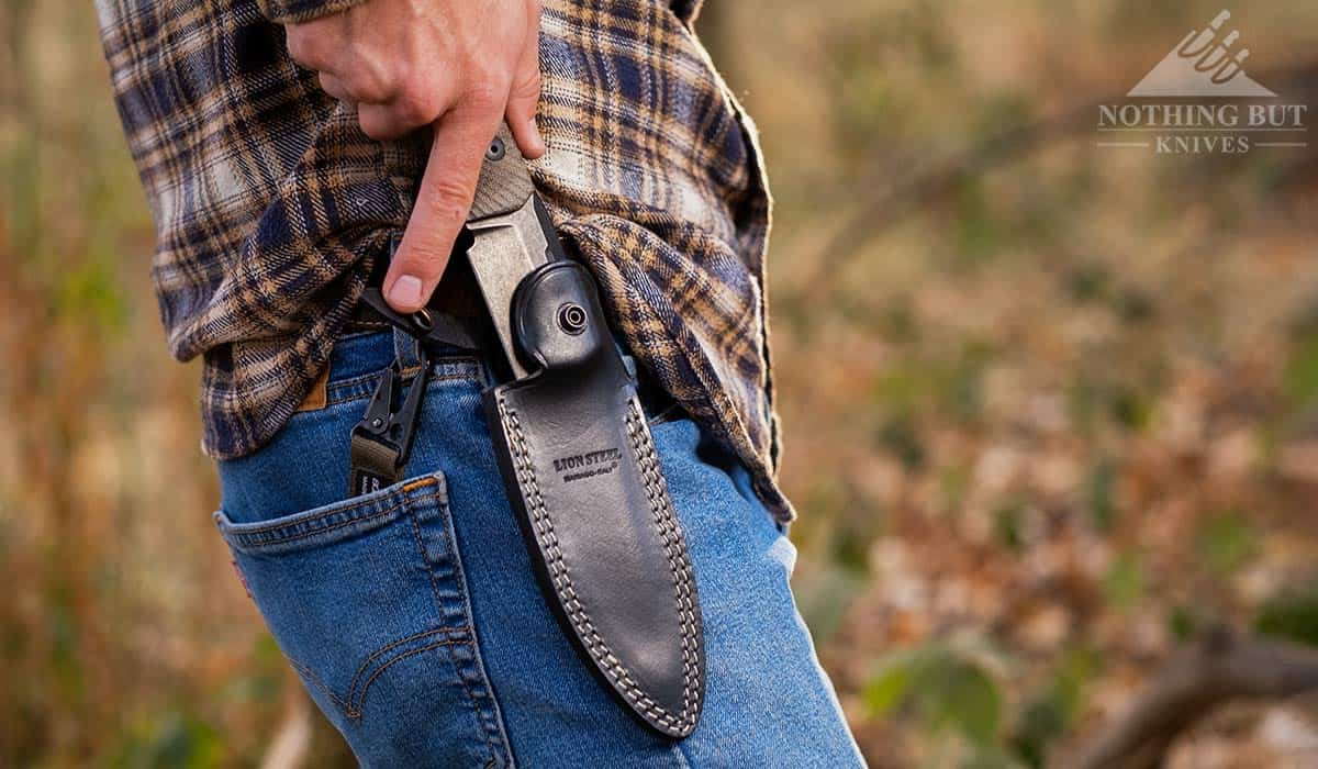 A close-up of a man's hand pulling the T5 from it's sheath. 