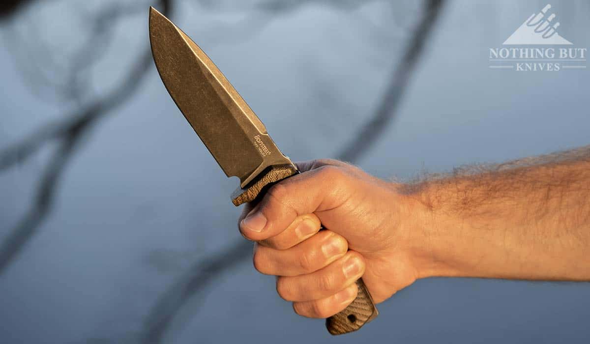 A man's hand holding the LionSteel T5 in a hammer grip. 