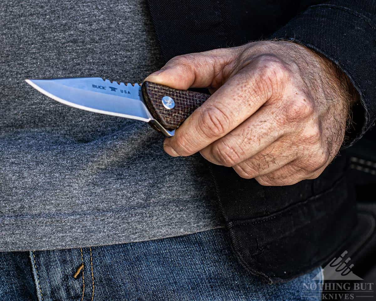 Conclusion image of the Buck Sprint Pro review showing the knife in a man's left hand. 