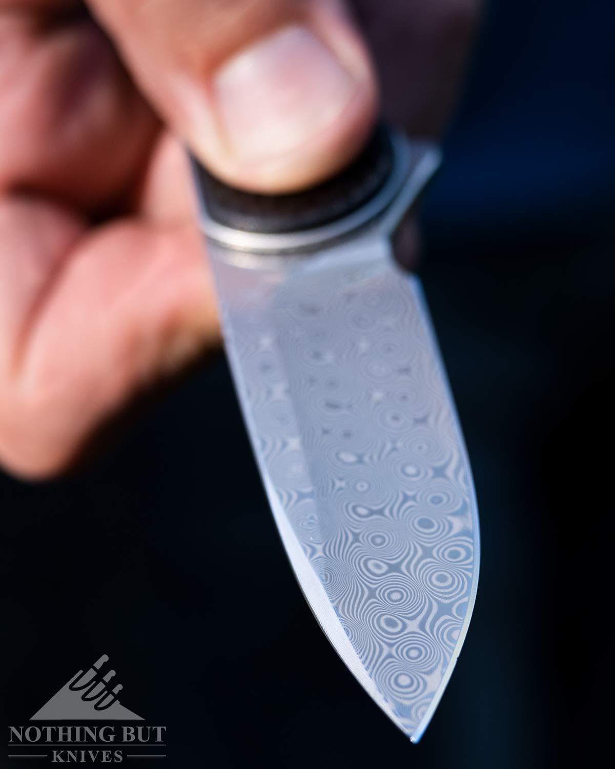 Close-up of the Civivi Elementum Damascus steel blade. 