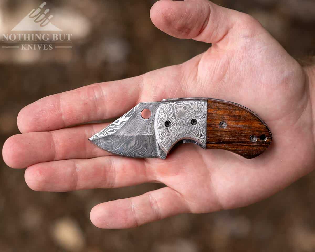 The Forseti Steel Lightholler pocket knife in the palm of a man's hand.