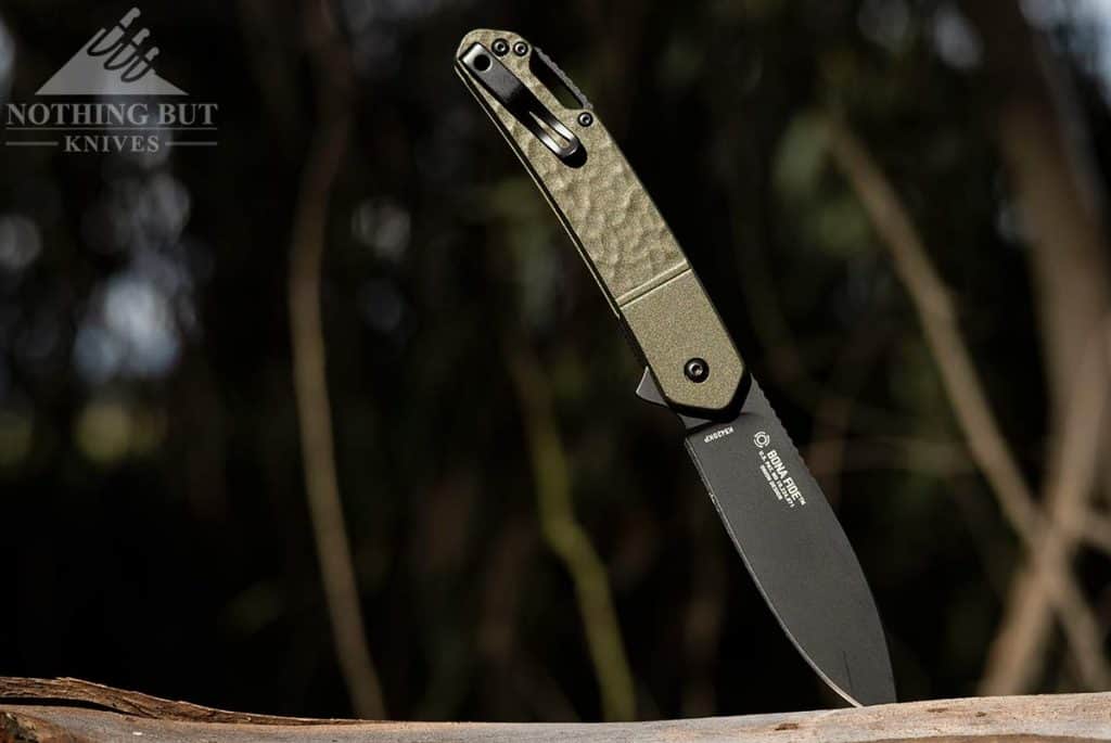 The CRKT Bona Fide OD Green outdoors in the forest.