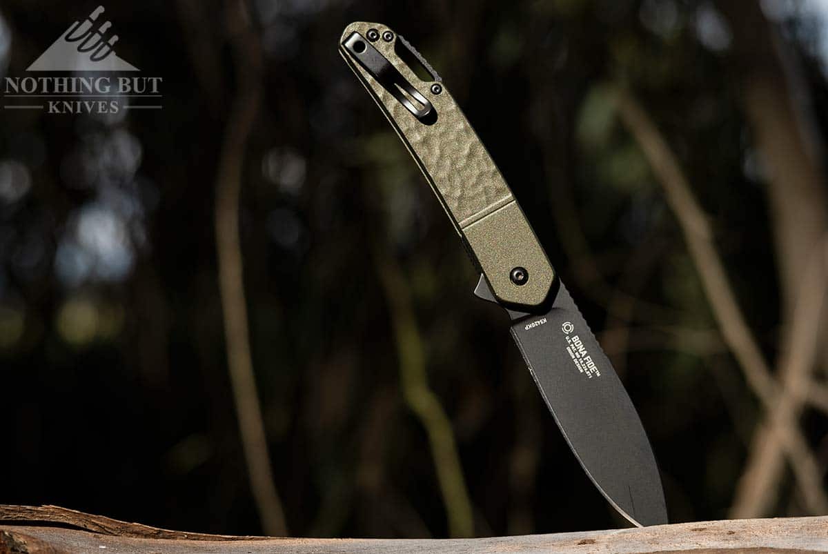 The CRKT Bona Fide OD Green outdoors in the forest. 