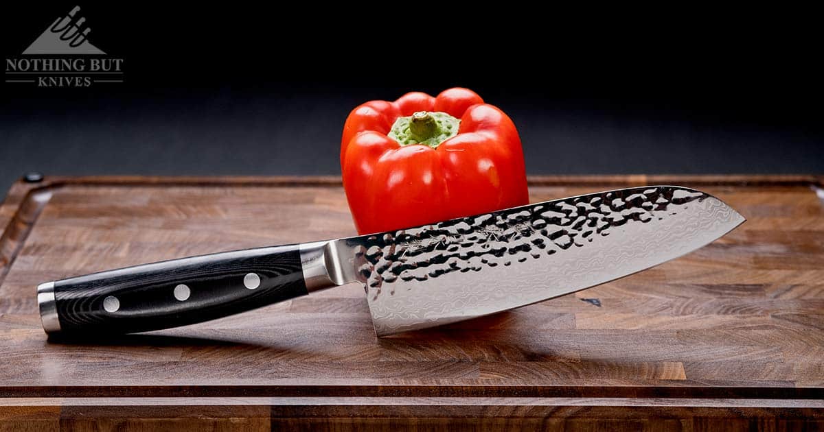 An alternate profile view of the Enso HD Santoku on an end grain cutting board. 