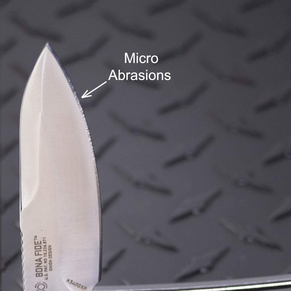 Crkt Bona Fide Review - Image 8 A close-up of the Bona Fide Silver blade with micro abrasions.